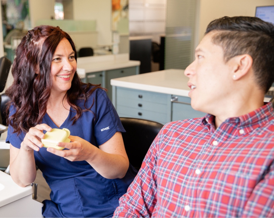 team member and young patient talking during visit
