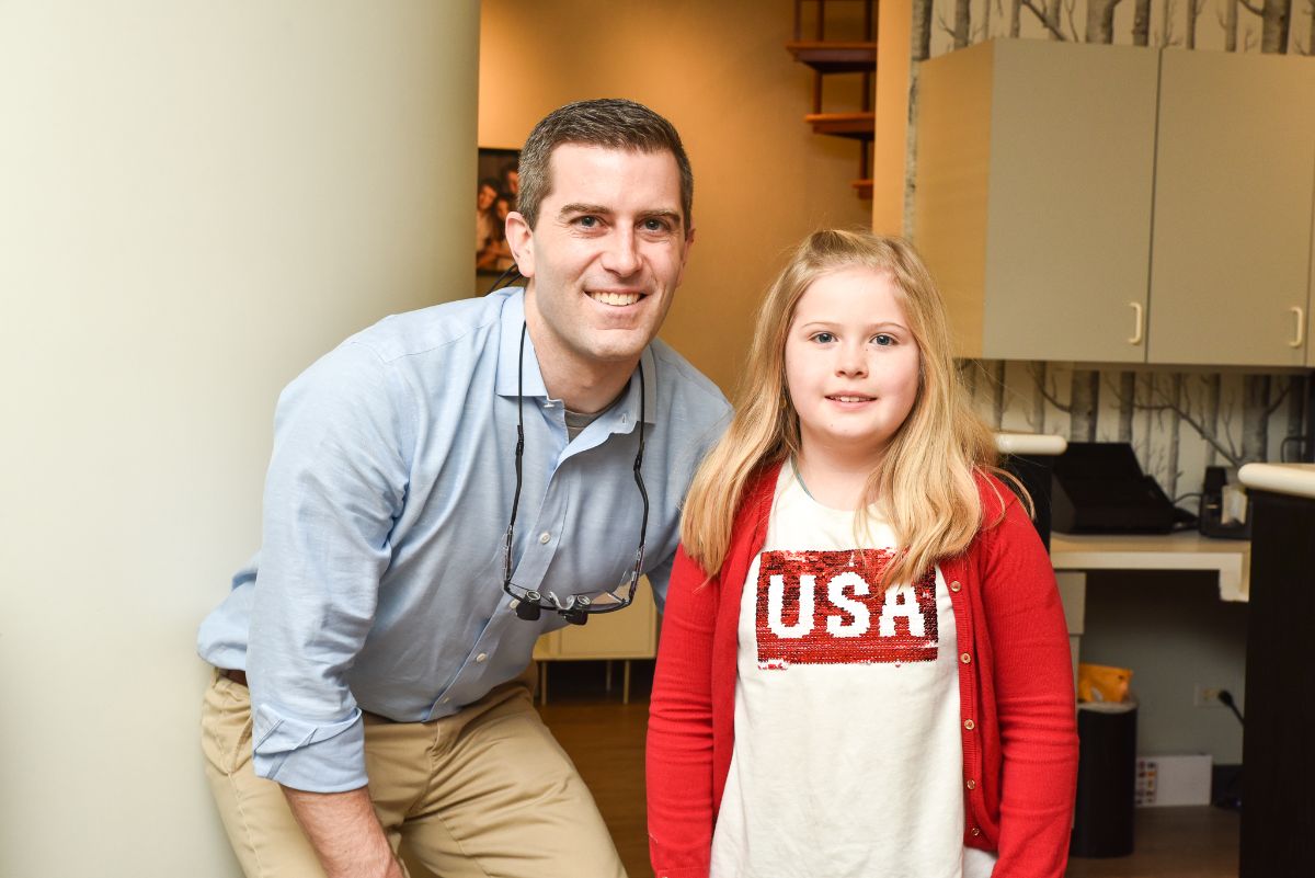 Dr. Brady smiling with a patient